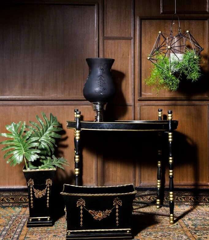 Sophisticated black and gold furniture and decor set against wood
